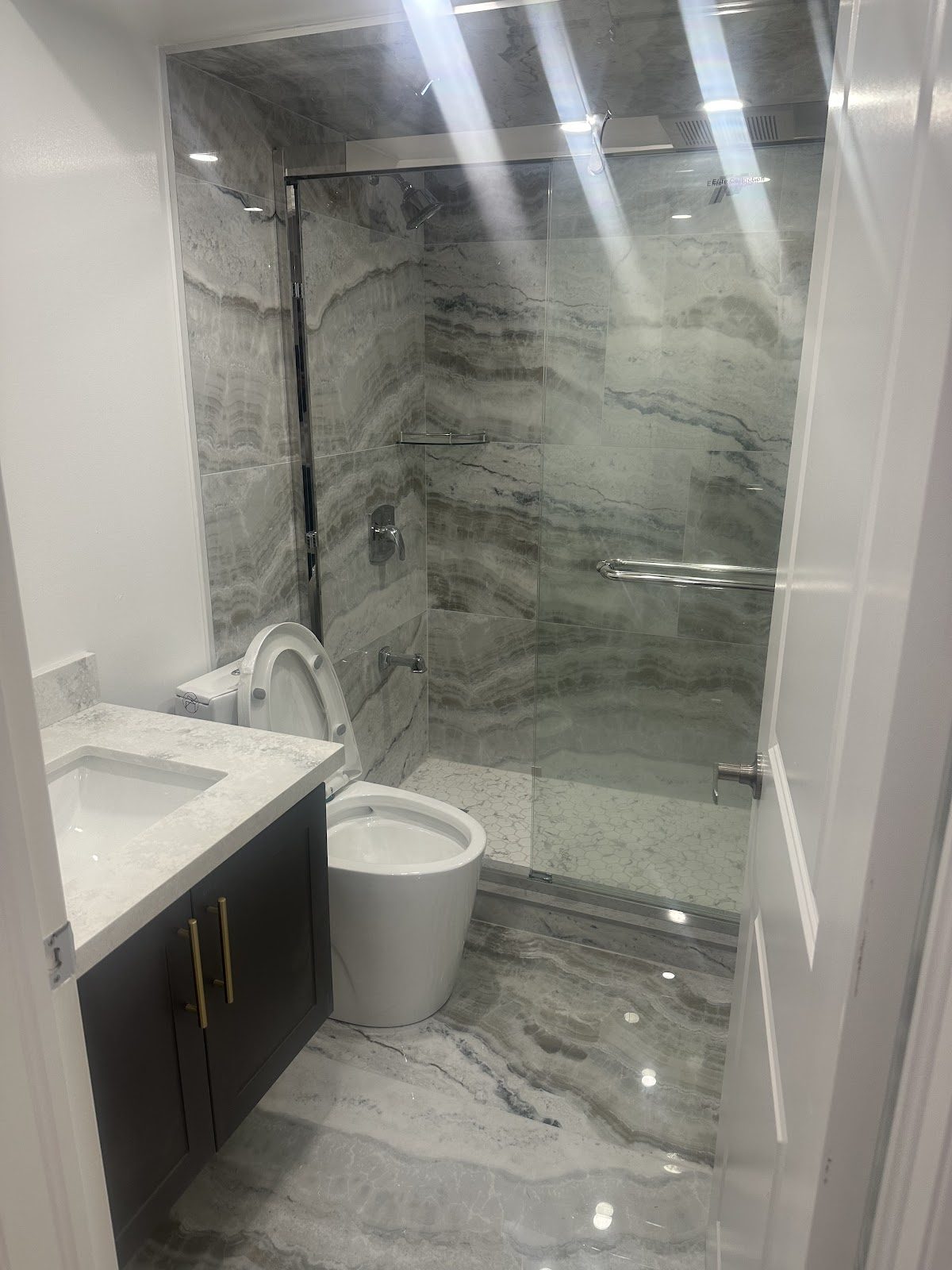 Real completed bathroom renovation with glass shower
